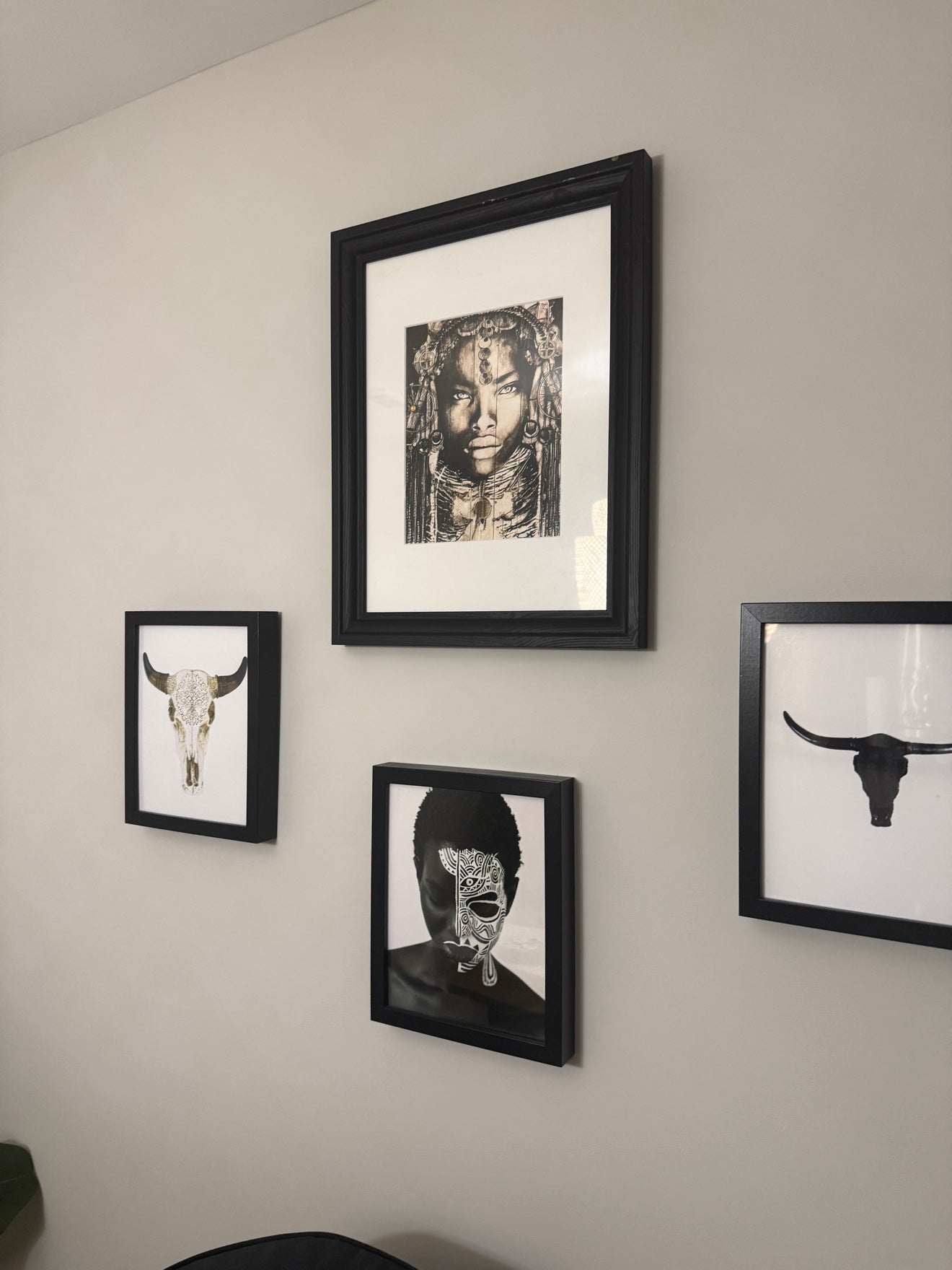 Framed African-diaspora art arranged on Erica's wall