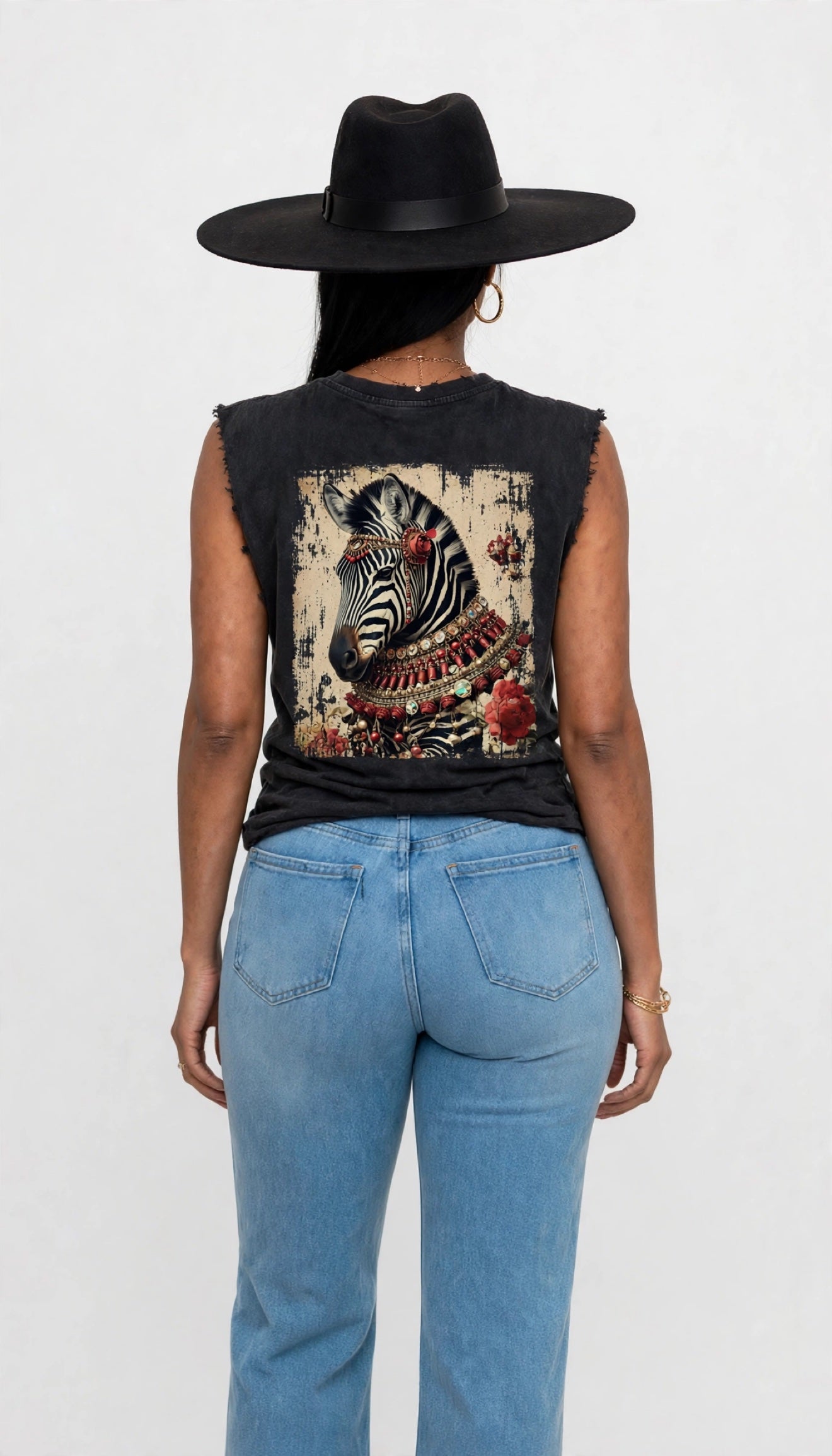 Back view of Erica modeling the black sleeveless cutoff tee with a large zebra graphic