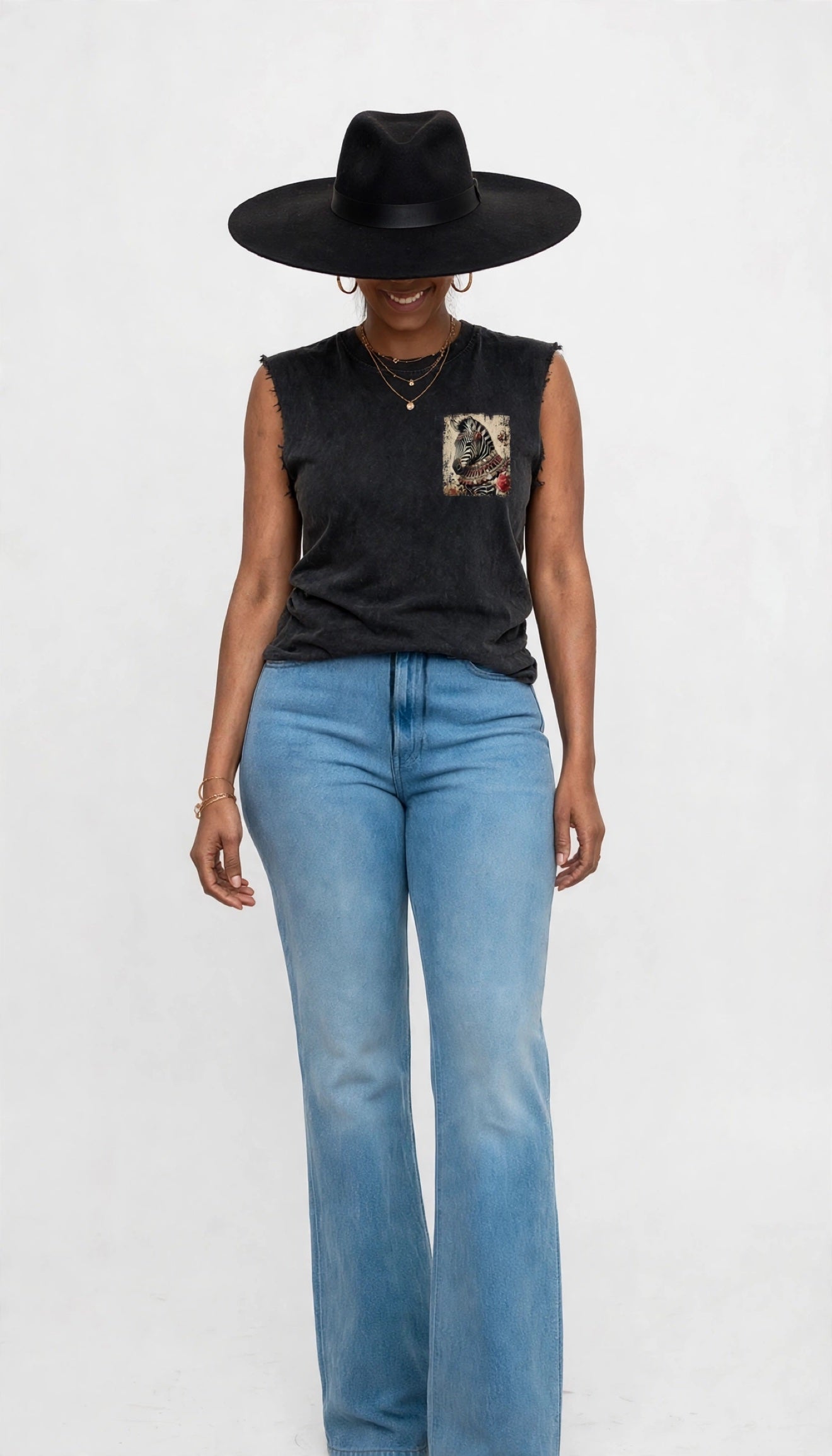 Erica modeling the black sleeveless cutoff tee with a zebra graphic