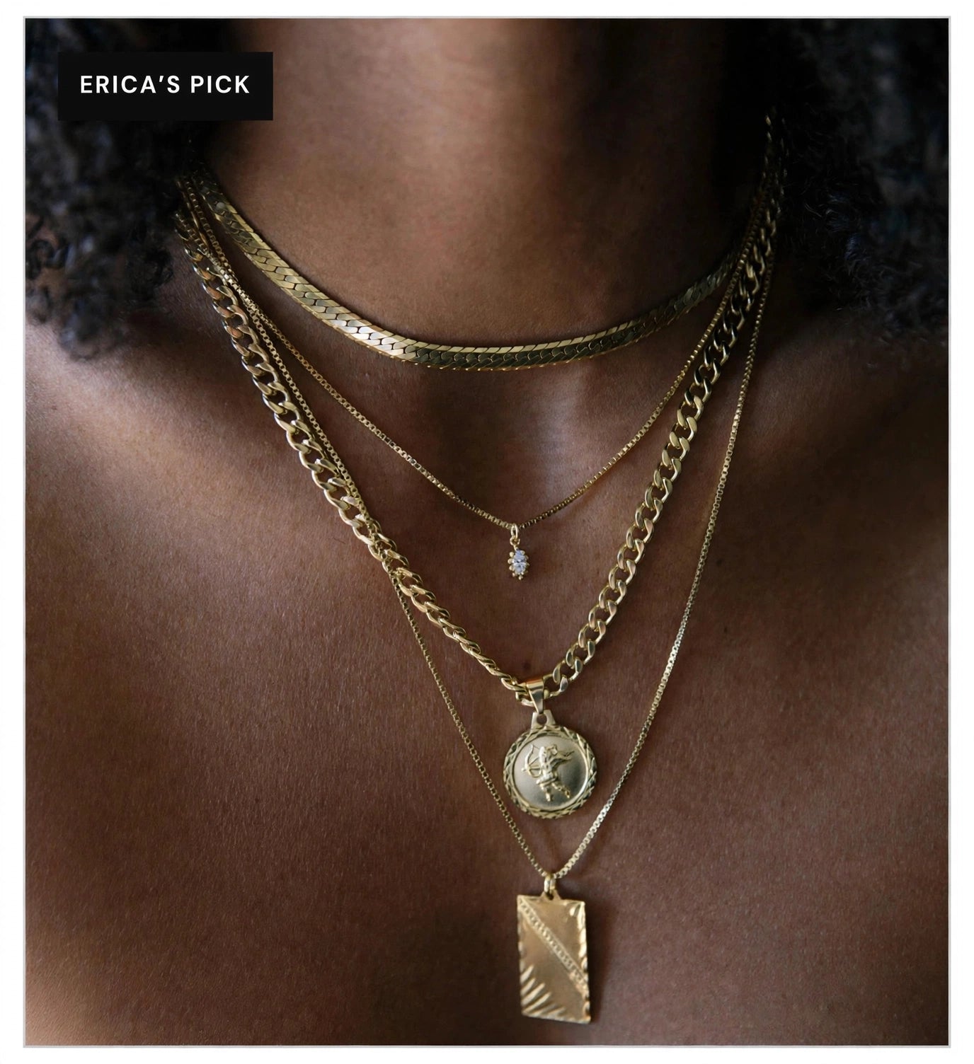 Layered gold necklaces shown in full on a Black woman