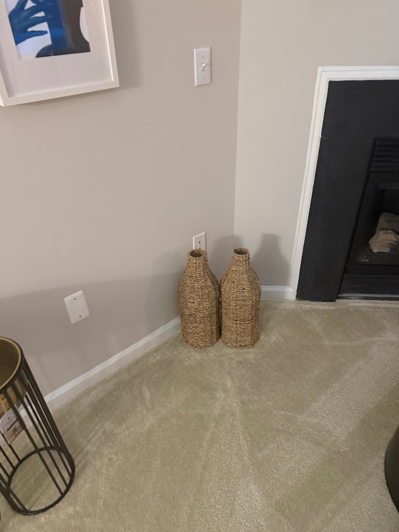 Woven decorative vases styled beside Erica's fireplace