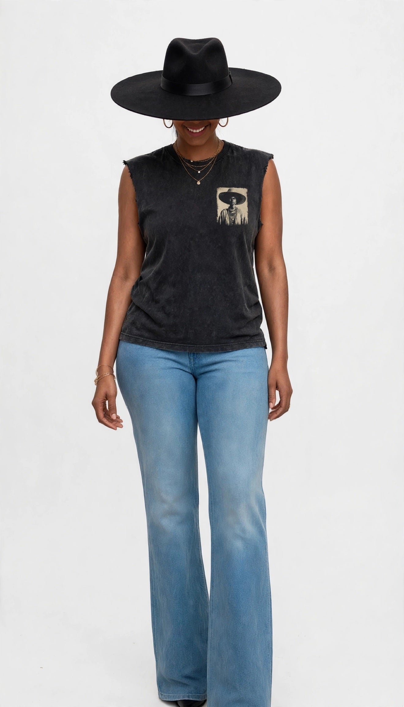 Erica wearing a black felt fedora and modeling the black sleeveless cutoff tee with a portrait graphic